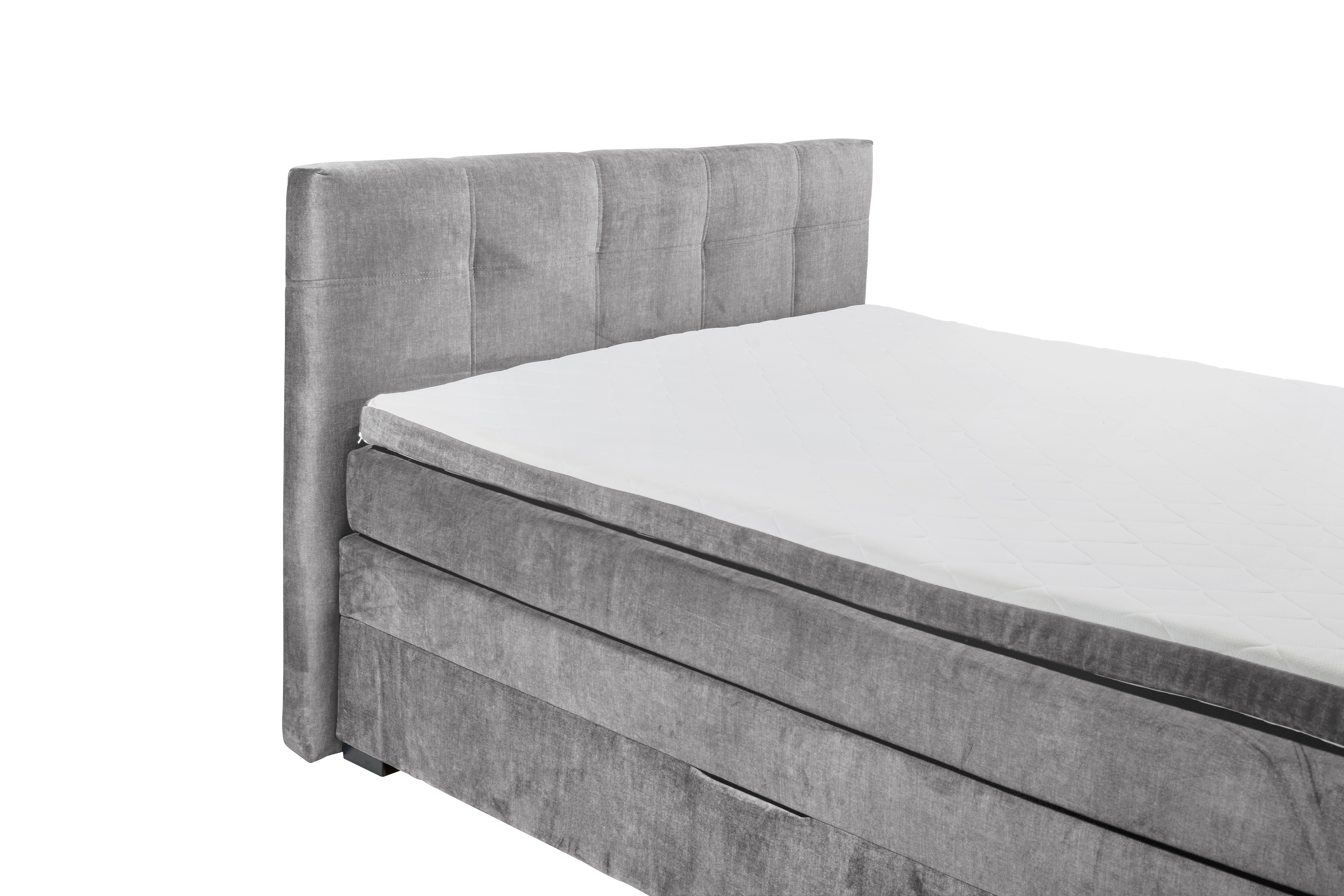 Boxspringbett „Vogue 15 grey“ aus schräger Perspektive nahe am Kopfteil fotografiert, grauer Stoffbezug, Kopfteil und Matratze im Detail sichtbar