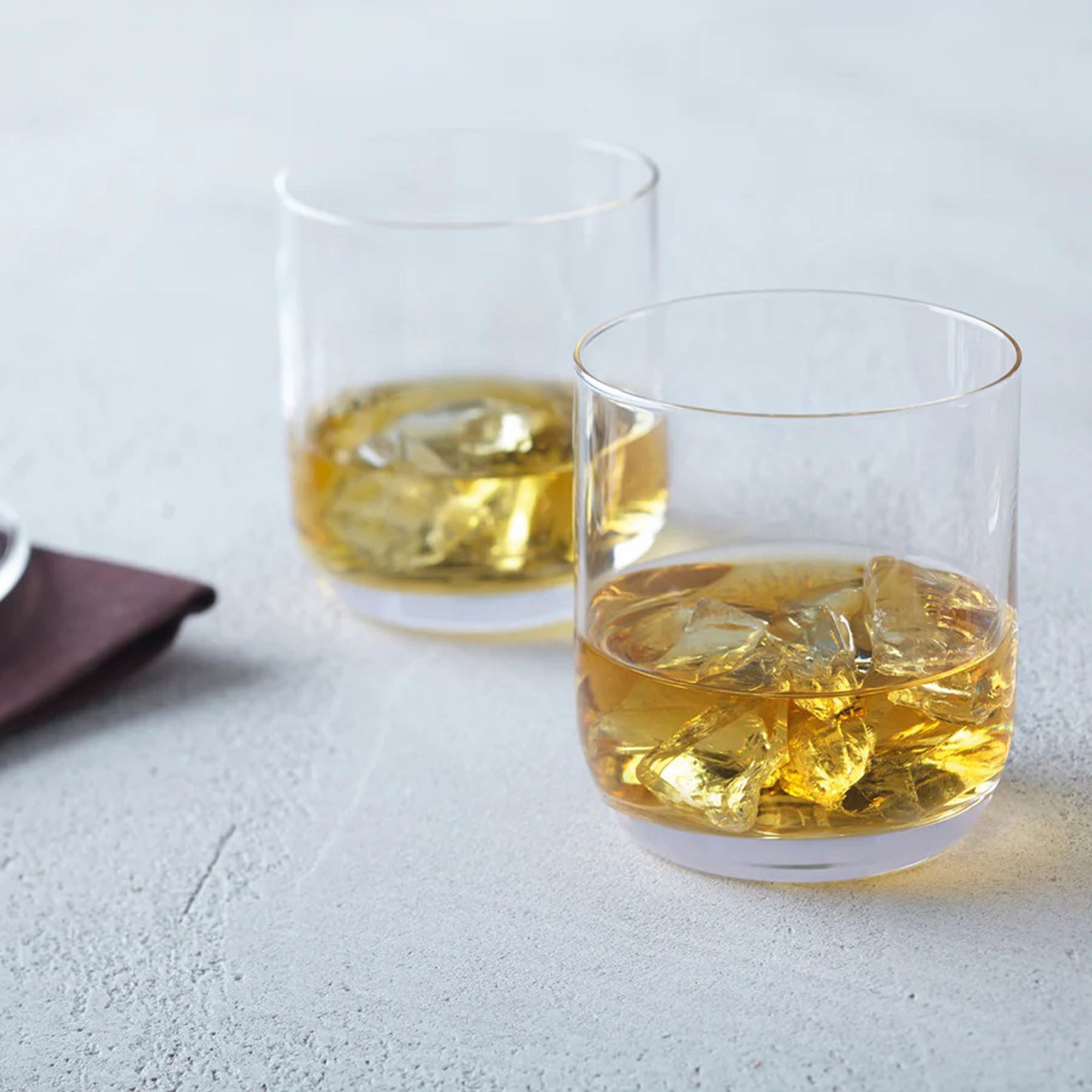 Kaesekuchen Bild1 altTextZwei Whiskygläser mit Eiswürfeln und goldfarbenem Getränk auf hellem Tisch