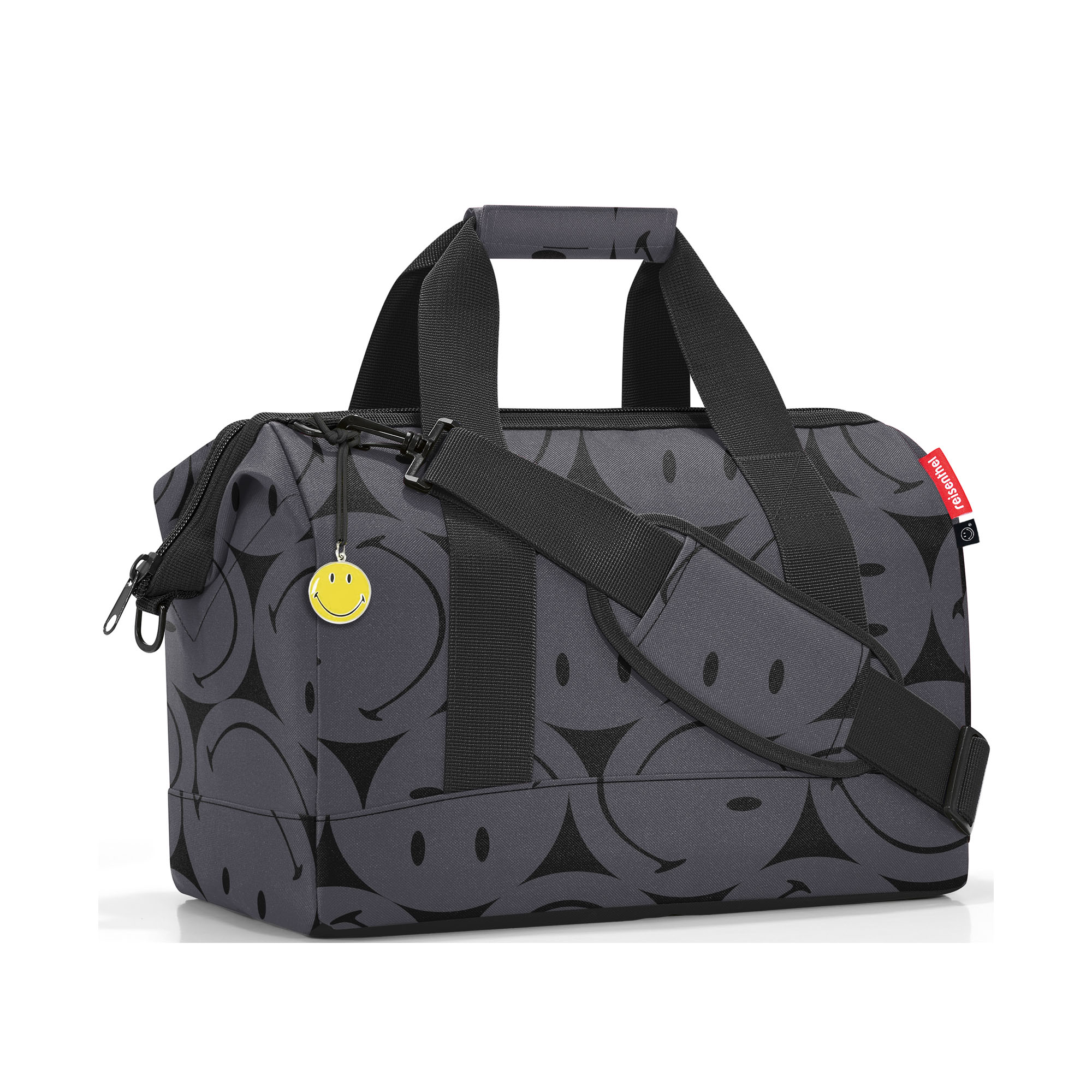 Reisetasche von Reisenthel, Modell Allrounder M, in Grau mit großflächigem Smiley-Muster, schräg von vorn mit Tragegriffen und Schultergurt.