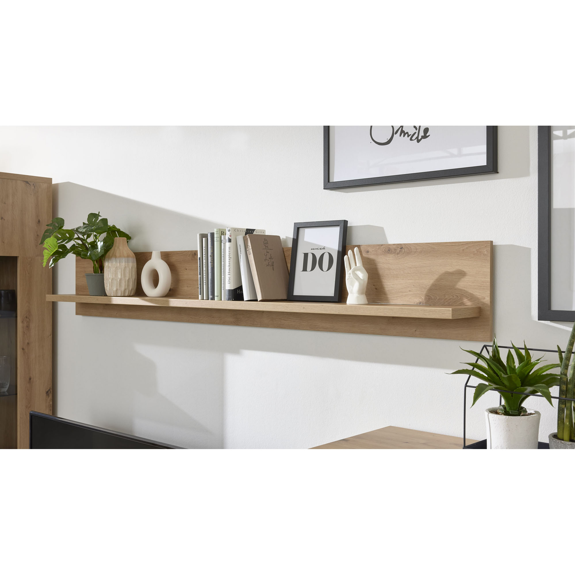 Interliving 2110 Wandboard in Holzoptik an der Wand montiert mit Büchern und Dekoration