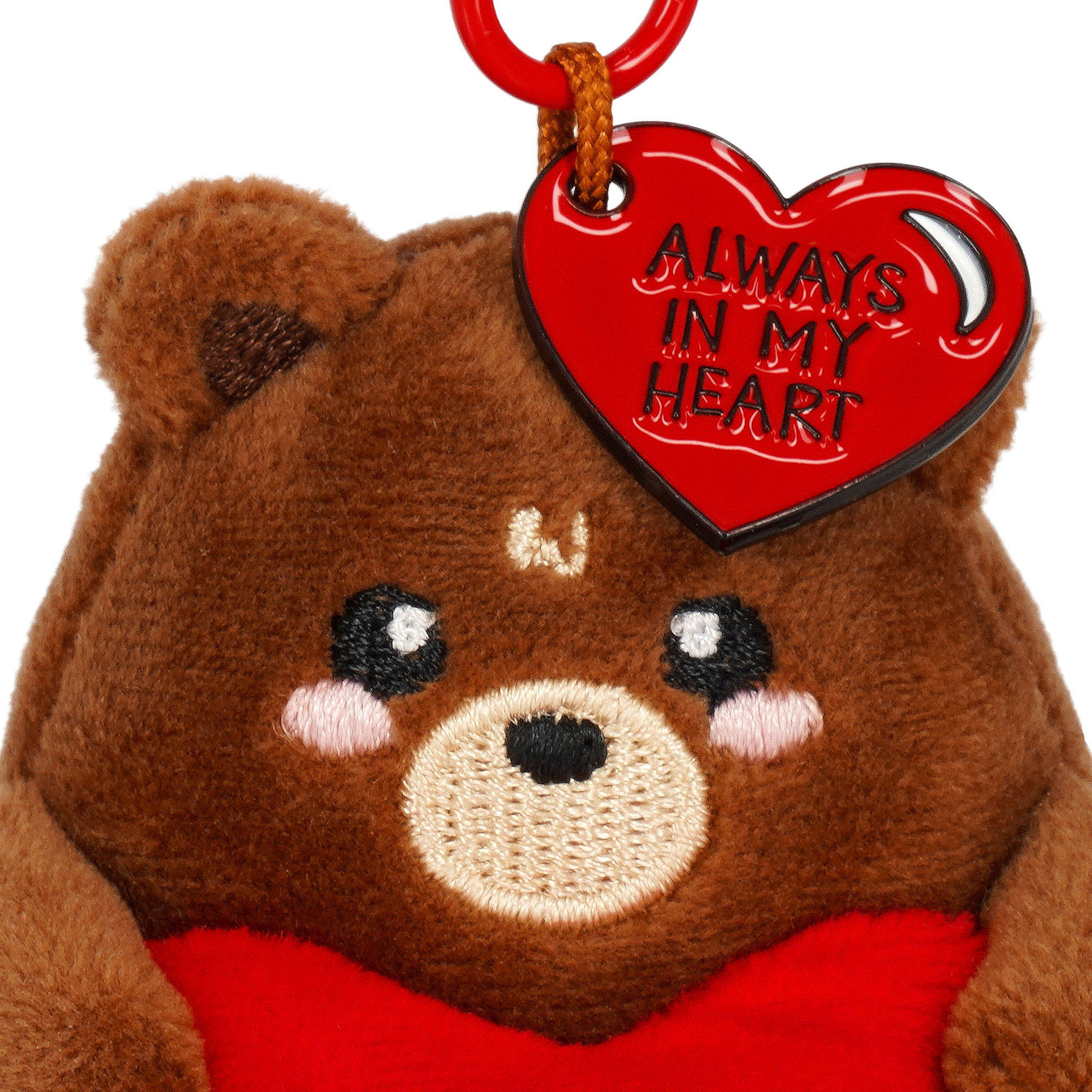 Brauner Teddybär-Plüsch-Schlüsselanhänger mit rotem Herz, in Nahaufnahme mit Gesicht und angenähtem Produktanhänger dargestellt.