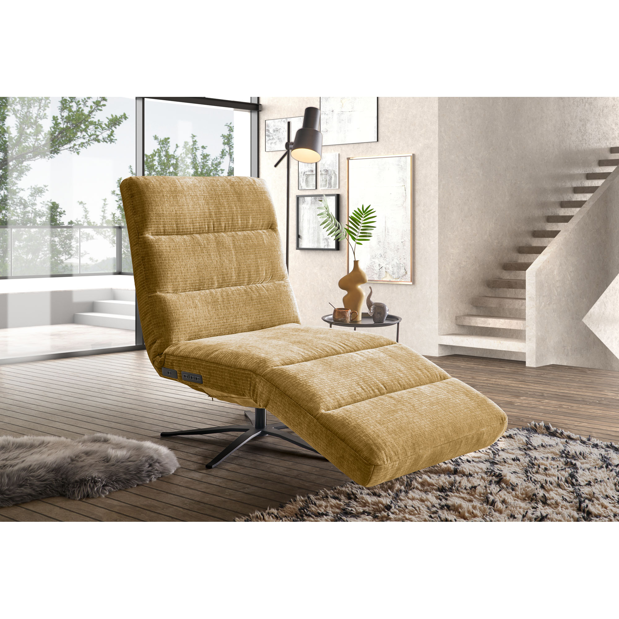 Relaxliege mit Bezug in Monty Pistaccio, gepolsterter Rückenlehne und schwarzem Sternfuß in einem hellen Wohnbereich mit Sofa, Teppich und Treppe
