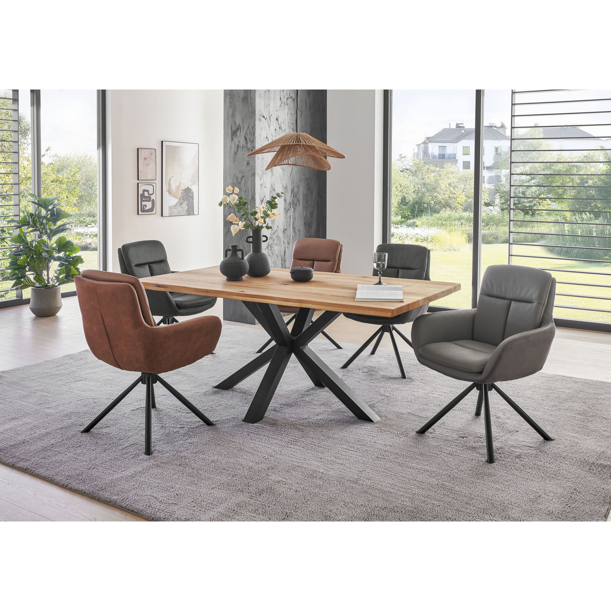Esszimmer mit Holztisch und Polsterstühlen in Schwarz, Braun und Grau auf hellem Teppich