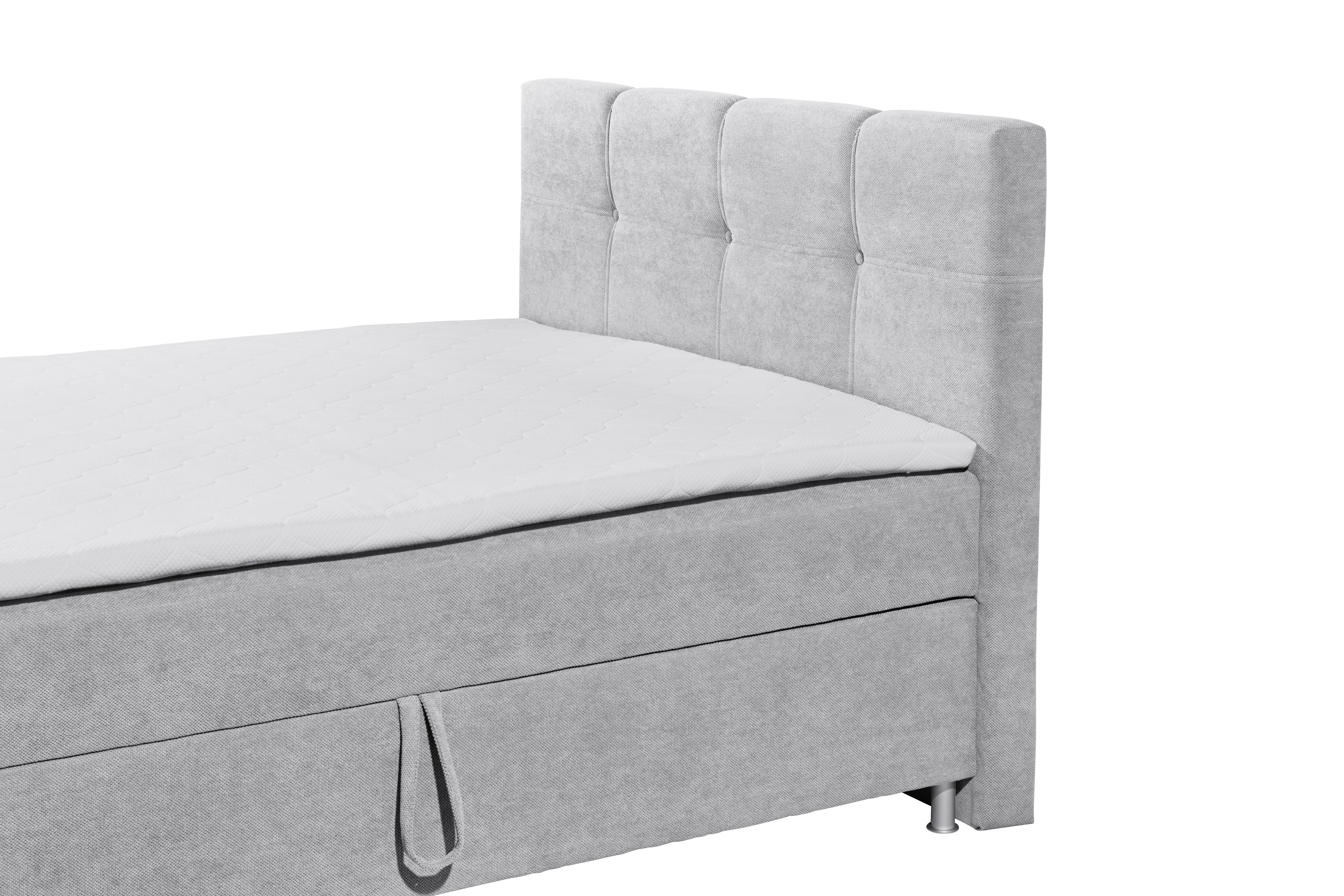 Boxspringbett „Curio 80 Silver“ aus schräger Perspektive nahe am Kopfteil fotografiert, silberner Stoffbezug und Kopfteil im Detail sichtbar