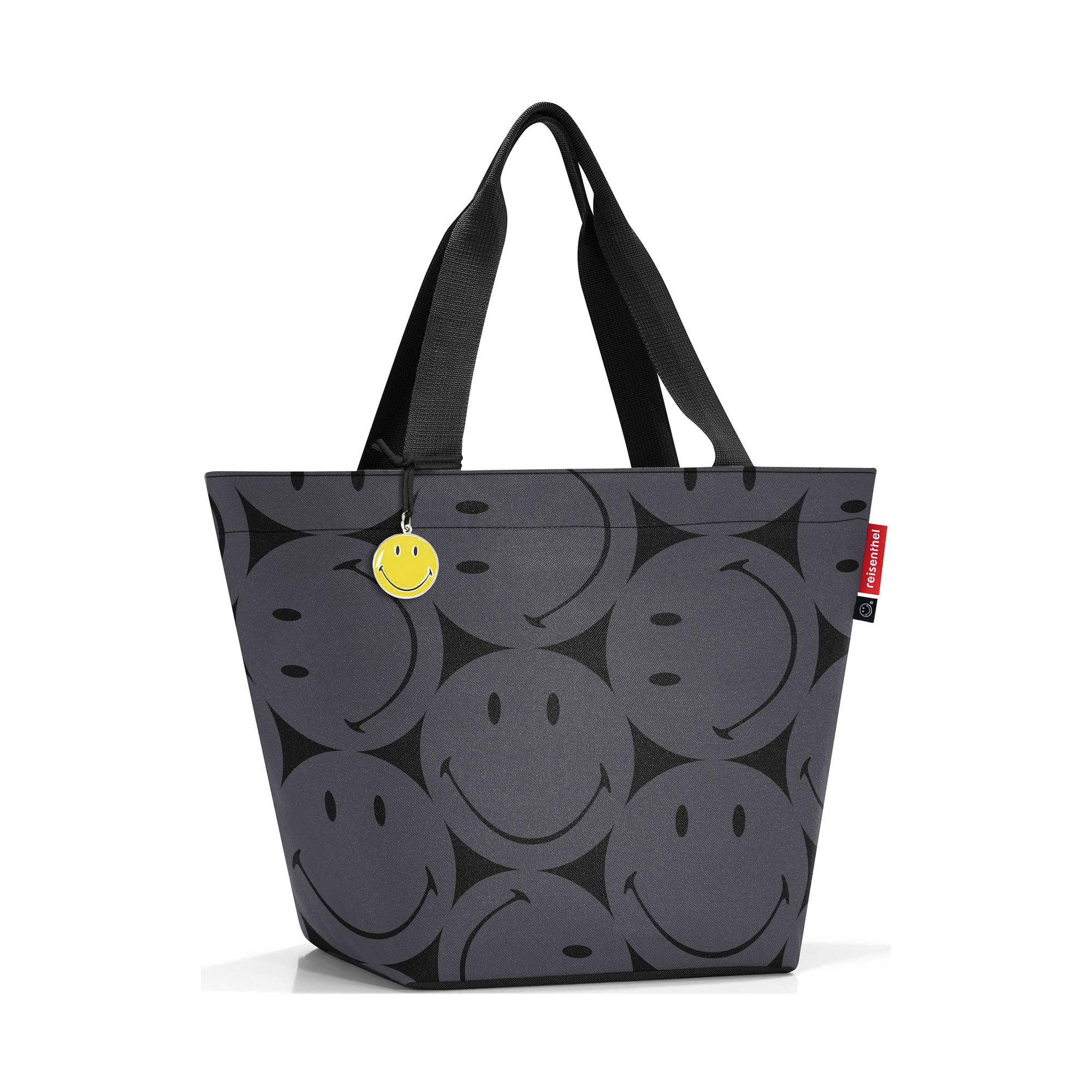 Shopper von Reisenthel, Modell Shopper M, in Grau mit großflächigem Smiley-Muster, frontal mit zwei langen Tragegriffen und gelbem Smiley-Anhänger.