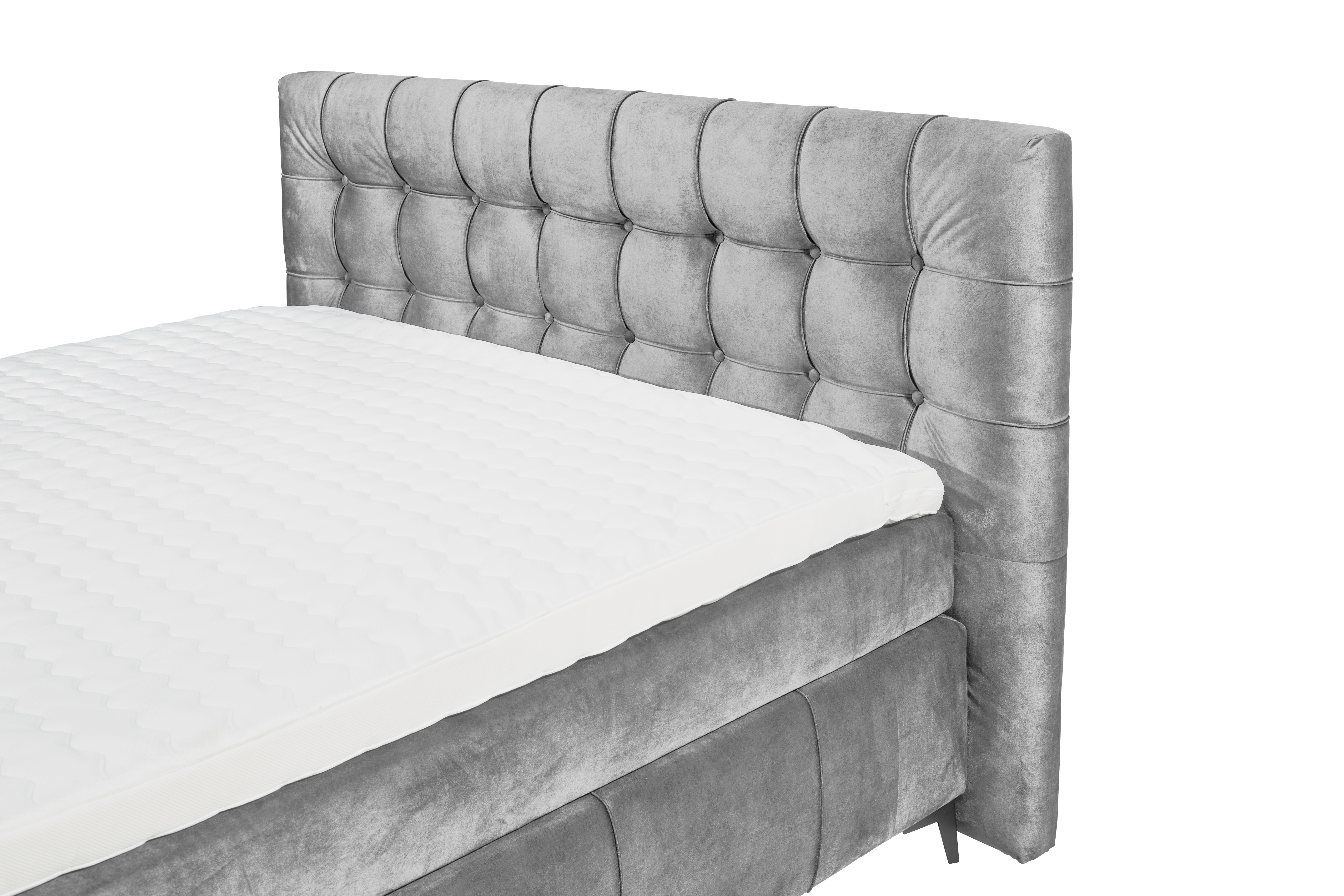 Boxspringbett in grauem Bezug, schräg aufgenommen, Fokus auf Kopfteil und Matratze, ohne Kissen