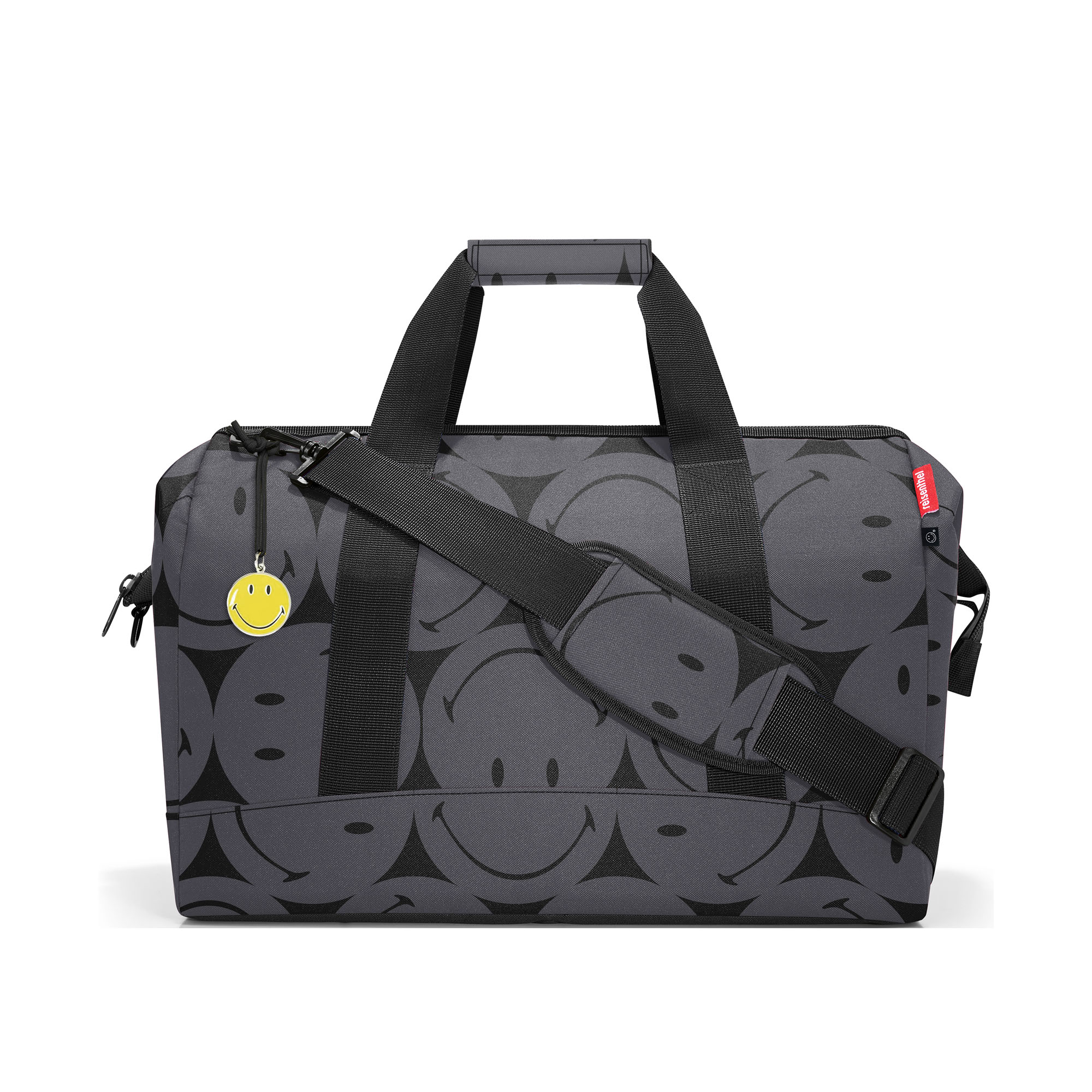 Reisetasche von Reisenthel, Modell Allrounder L, in Grau mit großflächigem Smiley-Muster, seitlich von vorn mit Tragegriffen und Schultergurt.