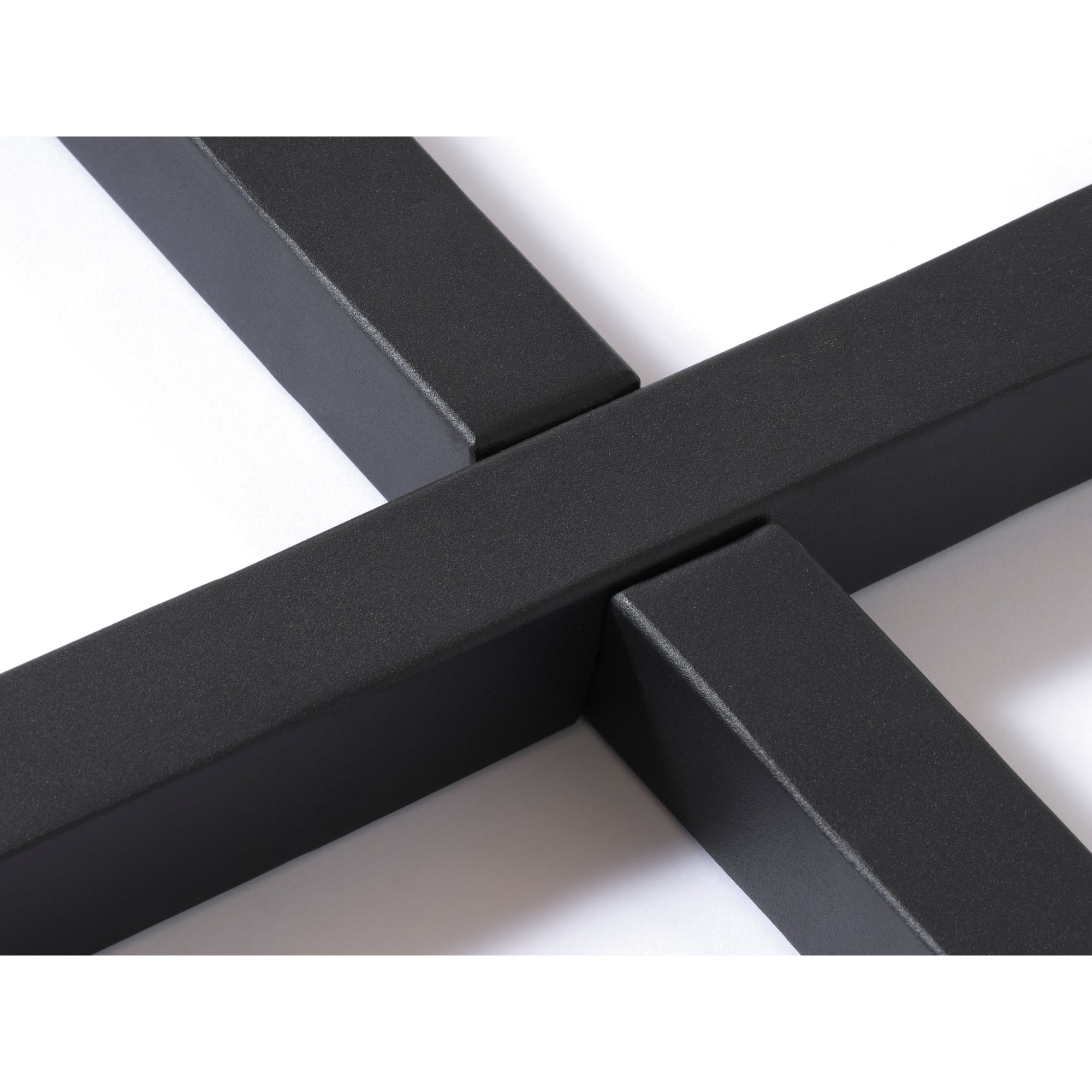 Moderner Esstisch mit runder Holzplatte und schwarzem Metallgestell in geschwungener Form, seitlich fotografiert.