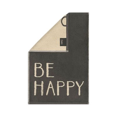Dunkelgraues Gästetuch Postcard Towels mit großem hellem Schriftzug „BE HAPPY“ und umgeschlagener heller Ecke.