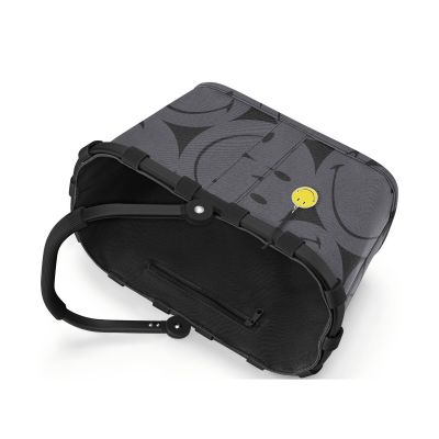 Kleiner Einkaufskorb von Reisenthel, Modell Carrybag XS, in Grau mit großflächigem Smiley-Muster, auf die Seite gelegt mit sichtbarem Rahmen und eingeklapptem Griff.