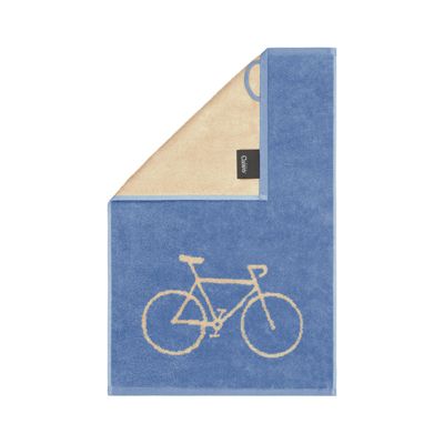 Blaues Gästetuch Postcard Towels in Capri mit hellem Fahrradmotiv; an der oberen Ecke ist die beige Rückseite sichtbar.