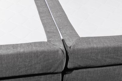 Boxspringbett „Vogue 15 grey“ schräg aufgenommen, Fokus auf die Tonnentaschenfederkern-Matratze, Detail der Liegefläche sichtbar