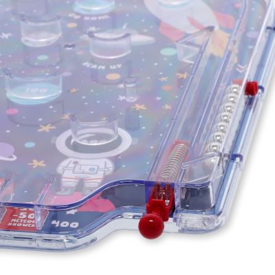 Mini-Flipperspiel mit Weltraummotiv, in Nahaufnahme mit transparentem Spielfeld und rotem Abschussmechanismus gezeigt.