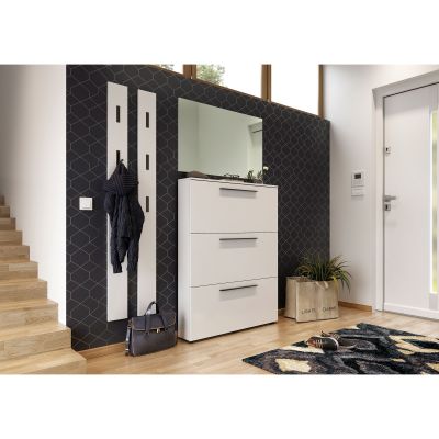 Weißer Schuhschrank mit drei Klappen in einem modern eingerichteten Flur vor dunkler Akzentwand