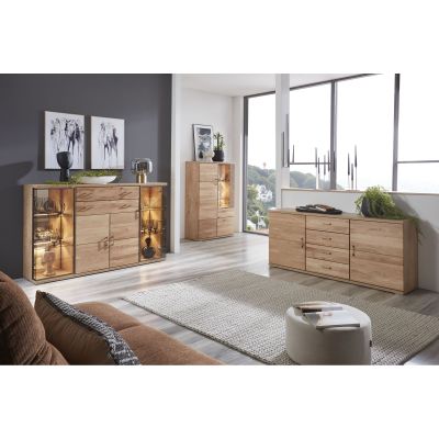 Sideboard in Alteiche mit Türen und Schubladen an einer dunklen Wand in einem hellen Wohnraum