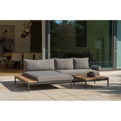 Garten Loungegruppe mit Ecksofa, Liegefläche und Beistelltisch auf einer Terrasse vor einer Glasfront
