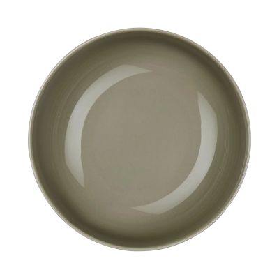 Arrangierte Szene: Buddha Bowl der Serie Coppa, Farbe Grün zusammen mit weiterem Geschirr auf einer gedeckten Fläche.
