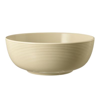 Schale in Sandbeige; rund und tief mit waagerechter Rillenstruktur. Ansicht: Seitenansicht.
