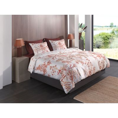 Bettwäsche Ceyda in White, 155 x 220 cm: bezogenes Bett in seitlicher Schlafzimmerszene mit filigranen roten, orangefarbenen und goldfarbenen Pflanzenmotiven auf weißem Grund.