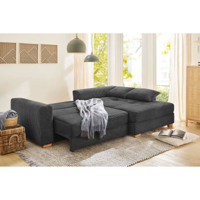 Polstergarnitur in Grau mit beigen Kissen, Stellmaß 288×186 cm, dargestellt in einem Milieubild im Wohnzimmer mit geöffnetem Bettkasten