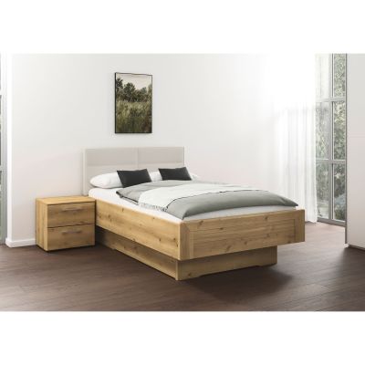 Nachttisch in Eicheoptik mit zwei Schubladen, passend zum Holzbett, in modernem Schlafzimmer mit großen Fenstern