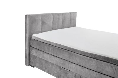 Boxspringbett „Vogue 15 grey“ aus schräger Perspektive nahe am Kopfteil fotografiert, grauer Stoffbezug, Kopfteil und Matratze im Detail sichtbar