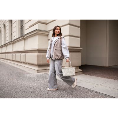 Kleiner Einkaufskorb von Reisenthel, Modell Carrybag XS, in hellem Steinbeige mit Steppstruktur, von einer Person am Tragegriff getragen