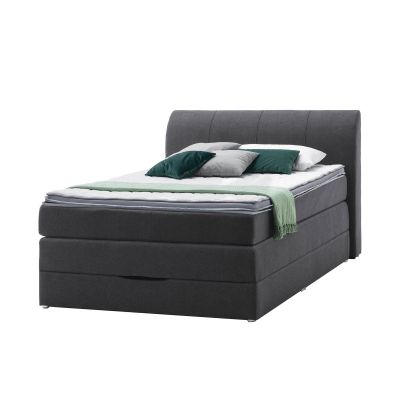 Boxspringbett mit hohem gepolstertem Kopfteil in schräger Ansicht von links mit mehrlagiger Matratze und dekorativen Kissen