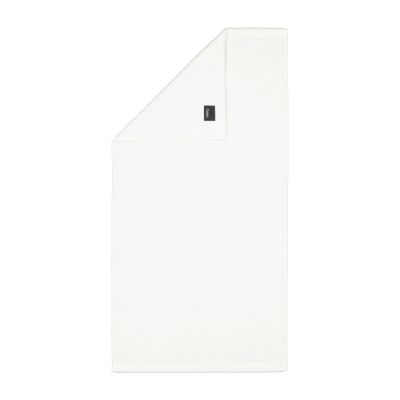 Handtuch in der Farbe Weiß mit umgeschlagener Ecke; Rückseite, Saum und kleines Textiletikett sind auf weißem Hintergrund sichtbar.
