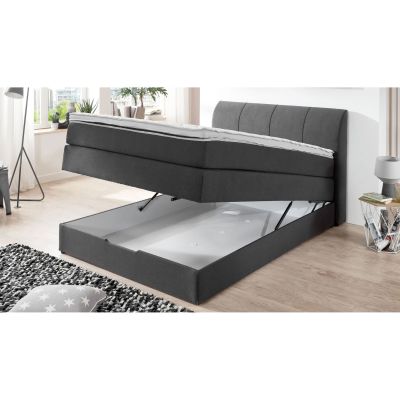 Boxspringbett mit angehobener Matratze in Frontansicht und freigelegtem Stauraum im Unterbau