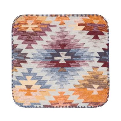 Flach dargestellte Kissenhülle Nomad Light mit zentralem Rautenmotiv in Rost, Blau, Gelb und Creme.