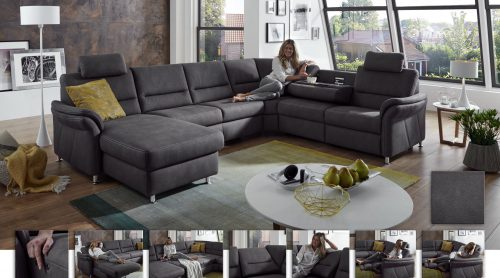 Modernes Wohnzimmer mit einem grauen Sofa von Möbel Gruber, einer entspannten Frau, großen Fenstern und einem runden weißen Couchtisch.