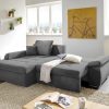 Modernes Wohnzimmer mit Funktions-Polsterecke-Sofa, Zimmerpflanze, Stehlampe und Fahrrad-Wandbild.