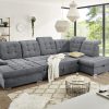 Modernes Wohnzimmer mit einem grauen Sofaelement von Möbel Gruber, einem geometrischen Couchtisch und großen Fenstern mit herrlicher Aussicht.